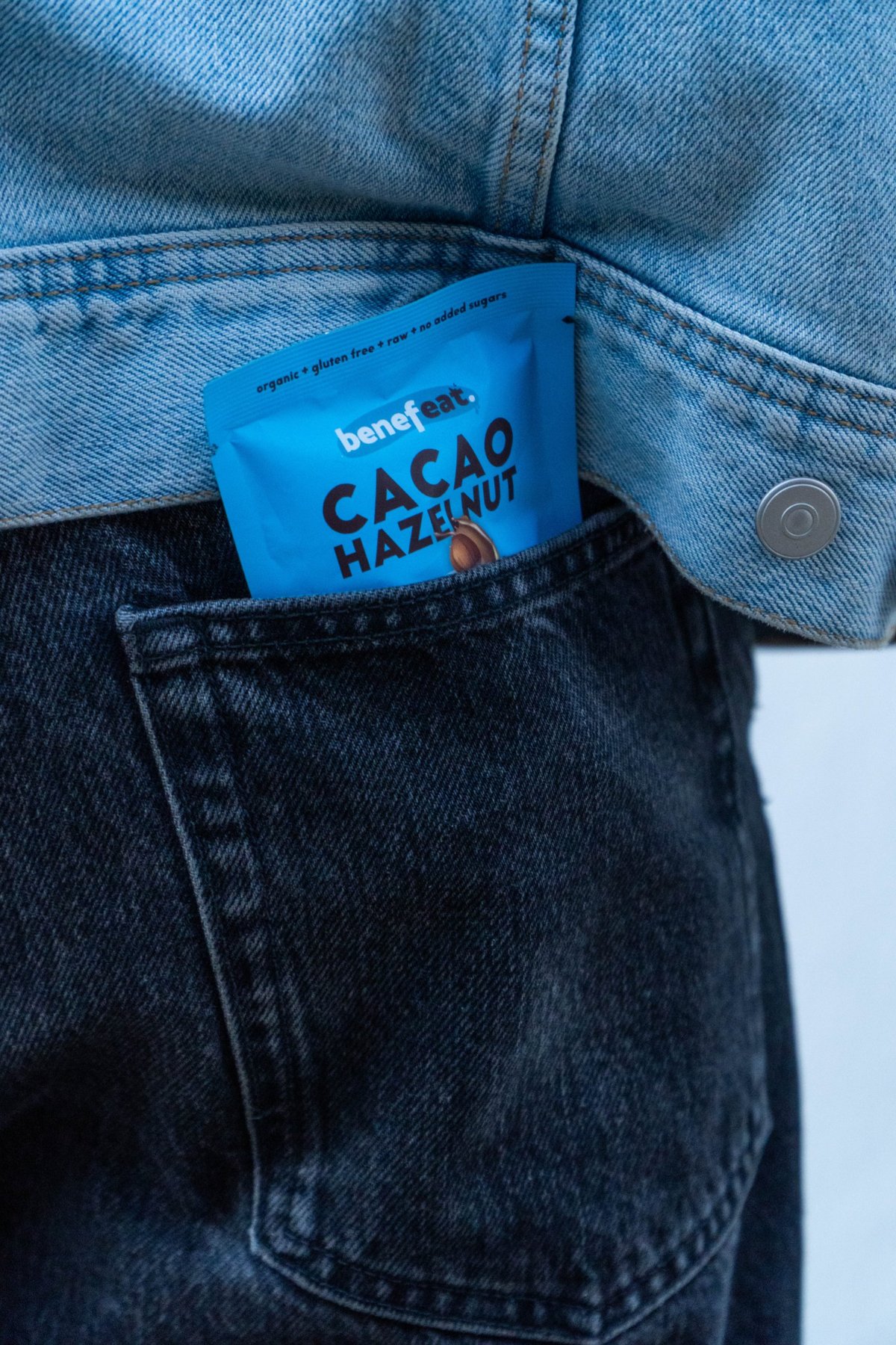 A Cacao Hazelnut churro pack tucked into a jeans back pocket